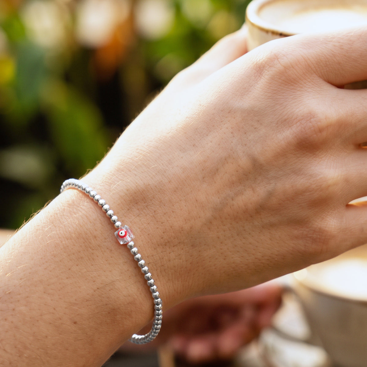 LUCKY CHARM. PULSERA DE ACERO INOXIDABLE CON OJO ROJO CUADRADO CRISTAL