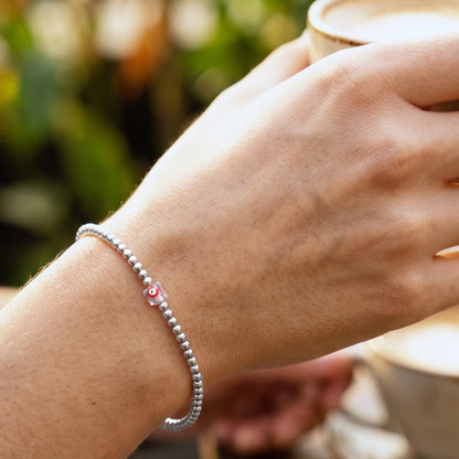 LUCKY CHARM. PULSERA DE ACERO INOXIDABLE CON OJO ROJO CUADRADO CRISTAL