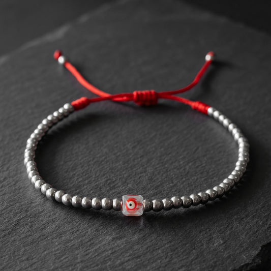 LUCKY CHARM. PULSERA DE ACERO INOXIDABLE CON OJO ROJO CUADRADO CRISTAL